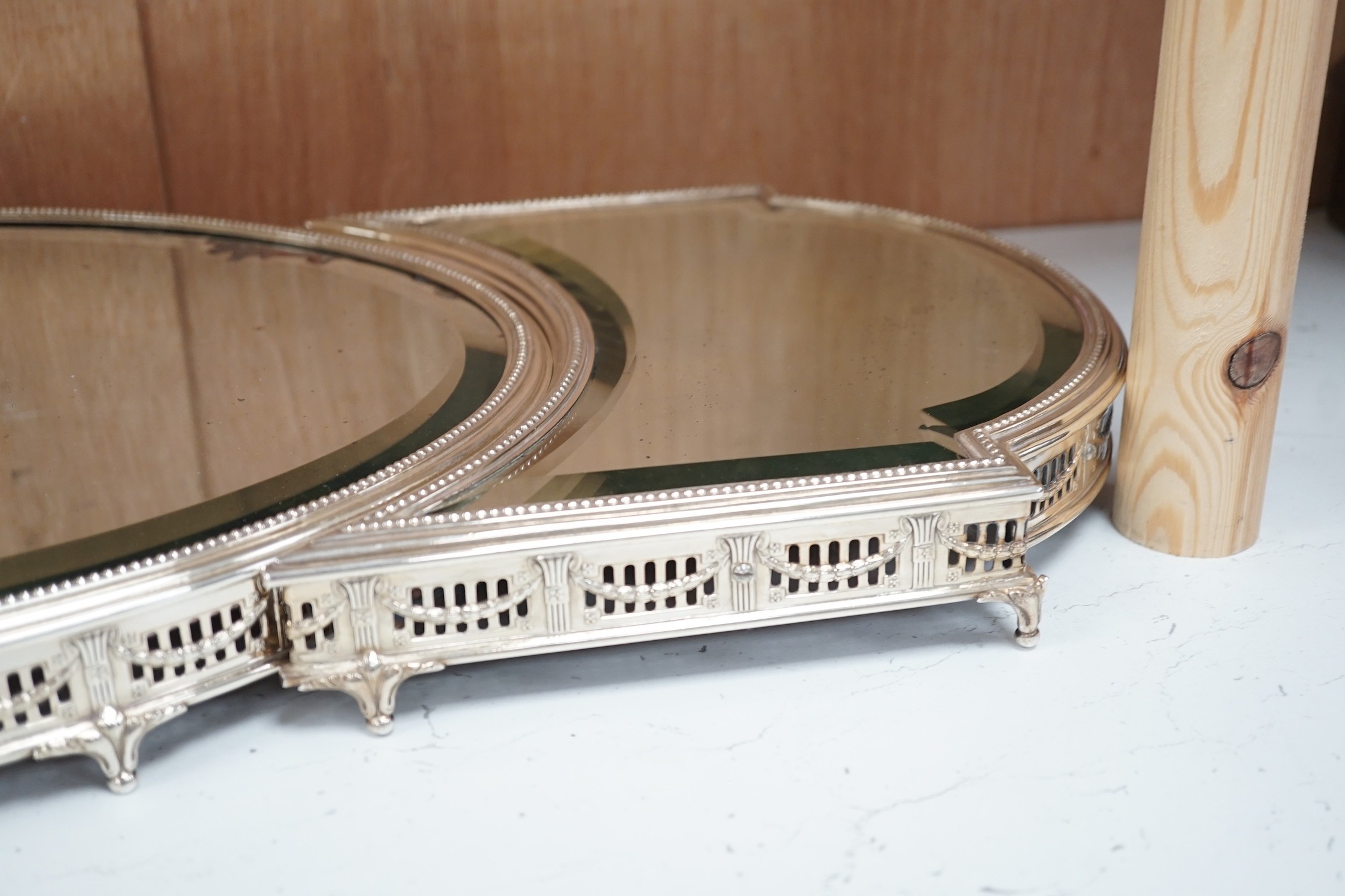 A silver-plated three-section mirrored plateau (surtout de table), by WMF, centre measures 53cm long